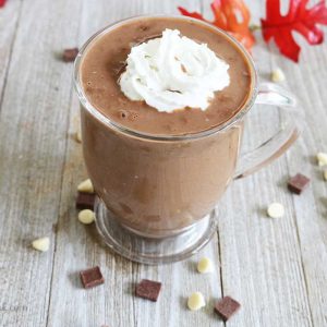 a cup of pumpkin spice hot chocolate with whipped cream on top