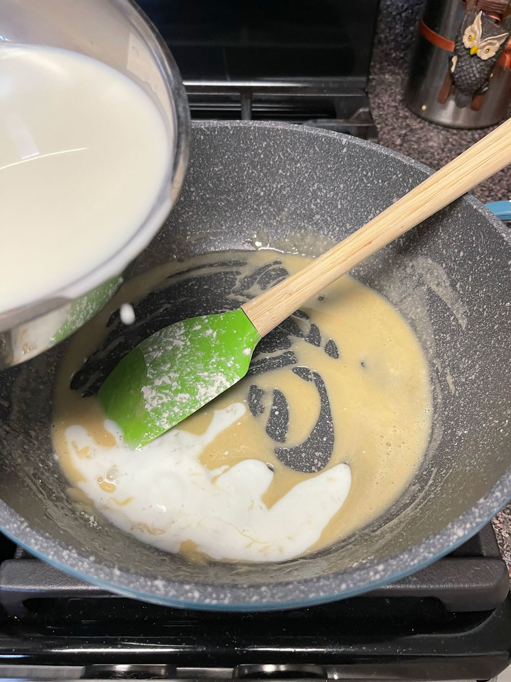 Slowly add the milk a little at a time, and keep a constant stirring. Make sure there aren't any clumps in the mix and let it simmer for 3-5 minutes until it thickens up a bit. Slowly add the milk a little at a time, and keep a constant whisk. Make sure there aren't any clumps in the mix and let it simmer for 3-5 minutes until it thickens up a bit.