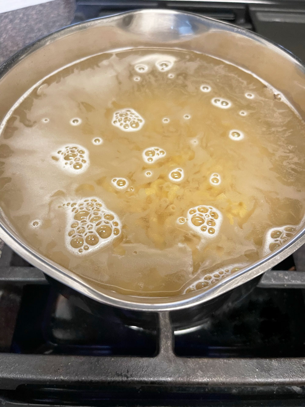 The first step is to cook the pasta. Cook macaroni according to the package directions. I cooked mine for 7 to 8 min. Gluten-free pasta will also work as long as you donโt overcook it. The-first-step-is-to-cook-the-pasta.-Cook-macaroni-according-to-the-package-directions.