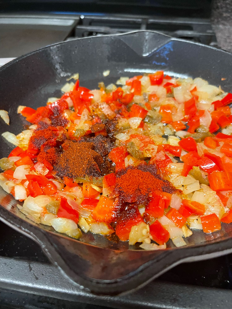 Add garlic, paprika, cumin, chili powder, salt, and pepper. Cook for 2 minutes, stirring constantly. Add-garlic,-paprika,-cumin,-chili-powder,-salt,-and-pepper.-Cook-for-2-minutes,-stirring-constantly.