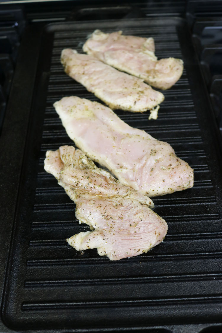 Heat a grill, grill pan, or cast iron pan to medium heat. Place the chicken on the grill and cook each piece for 3 minutes per side until the internal temperature reaches 165 degrees Fahrenheit. Grilled-Chicken-Breast
