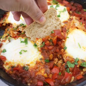 Shakshuka-is-a-tasty-dish-that-consists-of-a-combination-of-eggs,-tomatoes,-and-various-spices,-making-it-a-nutritious-and-fulfilling-option-for-any-meal-of-the-day.