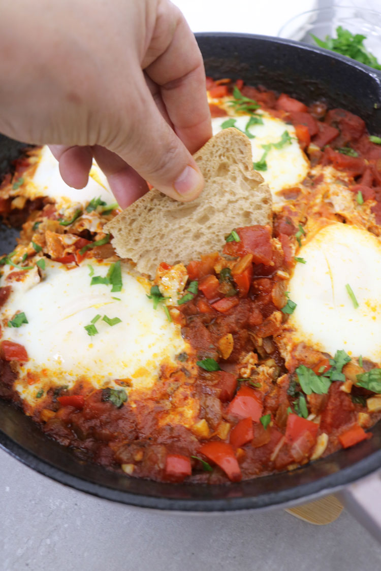 The best part is that it's versatile and can be enjoyed for breakfast, brunch, lunch, or dinner. You can easily adjust the recipe to suit your needs. Just use some crusty bread to scoop up all the delicious richness of the sauce. Shakshuka-is-a-tasty-dish-that-consists-of-a-combination-of-eggs,-tomatoes,-and-various-spices,-making-it-a-nutritious-and-fulfilling-option-for-any-meal-of-the-day.