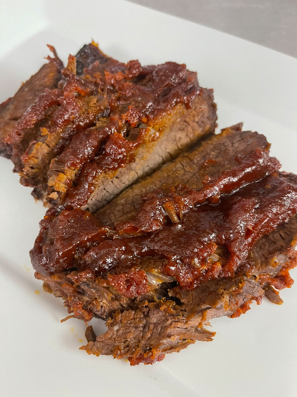This brisket is incredibly tender and flavorful. The meat is seasoned with an easy dry rub that enhances a delicious taste and is then simmered in a homemade BBQ sauce that will have you and everyone else licking their fingers. BRISKET-IN-A-HOMEMADE-BBQ-SAUCE-RECIPE.