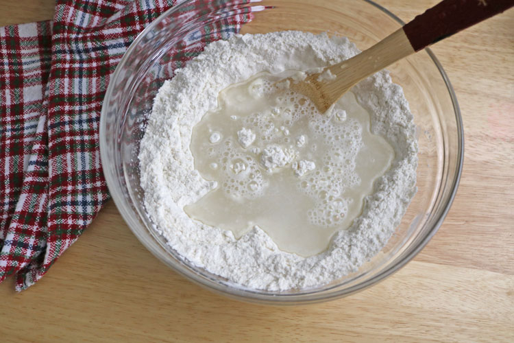 Add-lukewarm-water Add-lukewarm-water-and-mix-everything-to-form-a-rough,-lumpy,-and-craggy-dough.