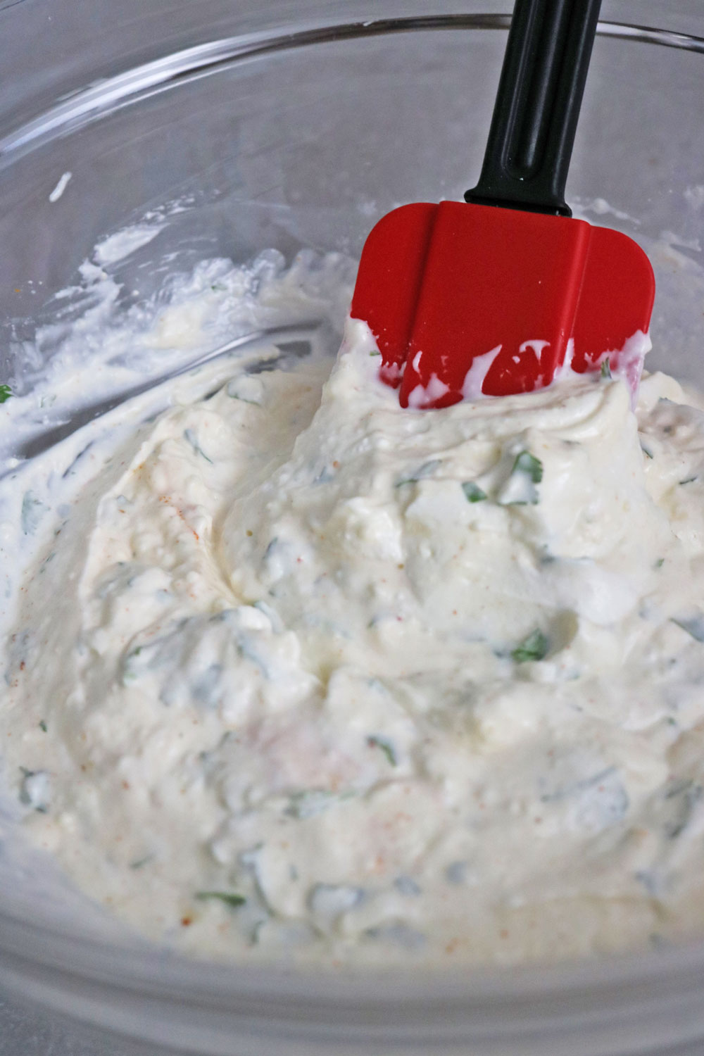 In-a-mixing-bowl,-add-sour-cream,-mayo,-fresh-garlic,-cayenne-pepper-for-a-little-spicy-kick,-lime-juice,-a-pinch-of-tajin-or-chili-pepper-and-a-generous-amount-of-Cotija-cheese. In-a-mixing-bowl,-add-sour-cream,-mayo,-fresh-garlic,-cayenne-pepper-for-a-little-spicy-kick,-lime-juice,-a-pinch-of-tajin-or-chili-pepper-and-a-generous-amount-of-Cotija-cheese.