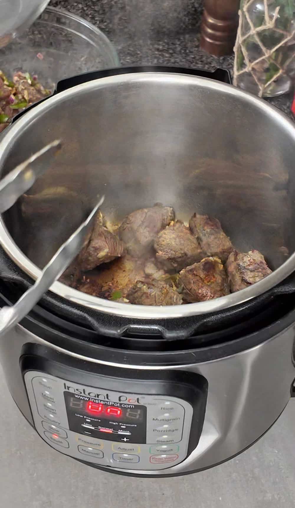 Once the oil is hot, add some of the cubed meat in batches. It's important not to overcrowd the pressure cooker to ensure the meat gets a nice color. I recommend doing it in three batches. Once the oil is hot, add some of the cubed meat in batches. It's important not to overcrowd the pressure cooker to ensure the meat gets a nice color. I recommend doing it in three batches.