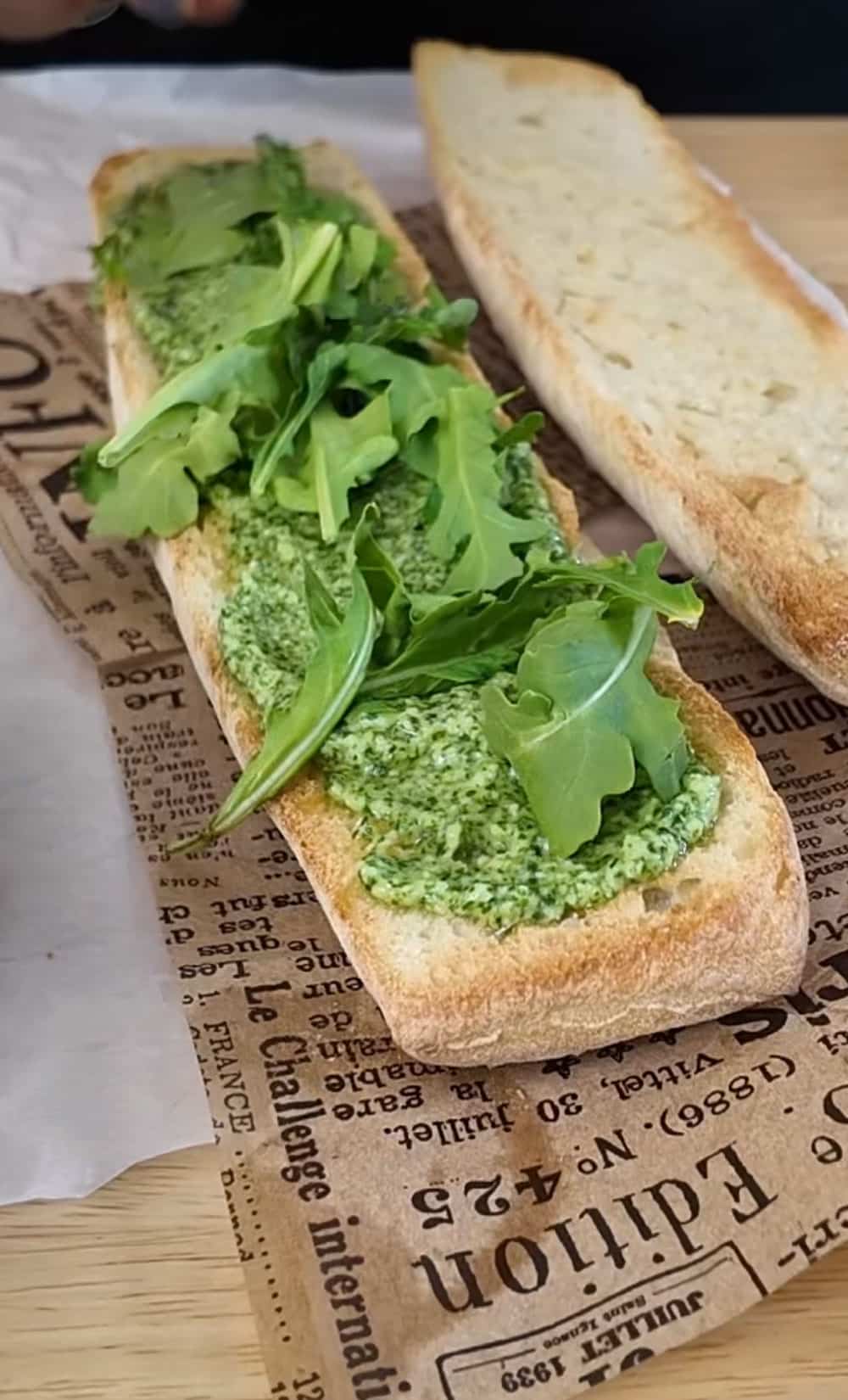 Add some arugula Spread-pesto-on-the-bottom-half-of-the-toasted-ciabatta-or-baguette-and-layer-fresh-arugula-on-top