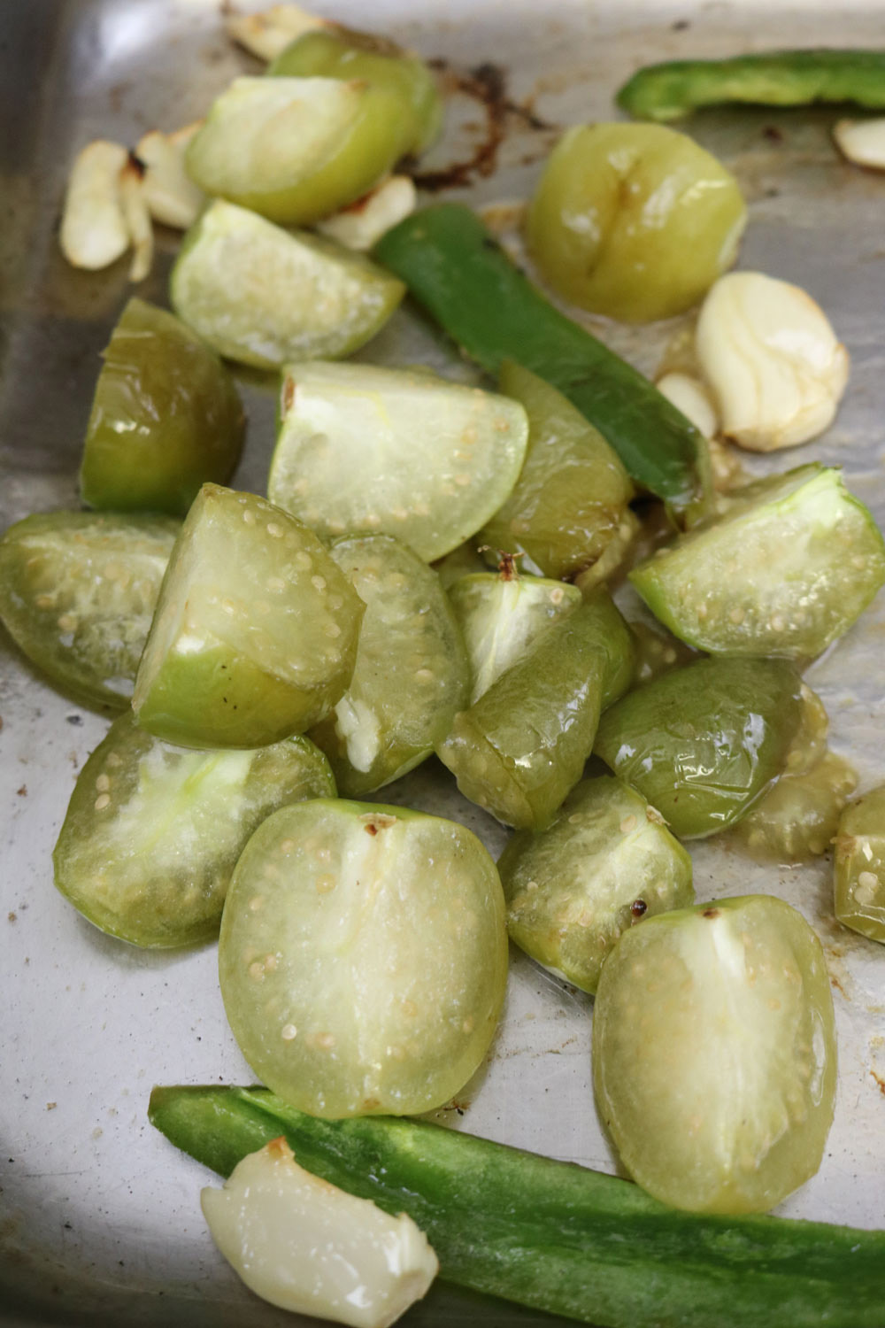 Toss the tomatillos, garlic, and jalapeรฑo on a rimmed baking sheet with the oil and spread in a single layer. Roast the vegetables until lightly charred and softened, about 12 minutes. Toss-the-tomatillos,-garlic,-and-jalapeno-on-a-rimmed-baking-sheet-with-the-oil-and-spread-in-a-single-layer.-Roast-the-vegetables-until-lightly-charred-and-softened,-about-12-minutes.-