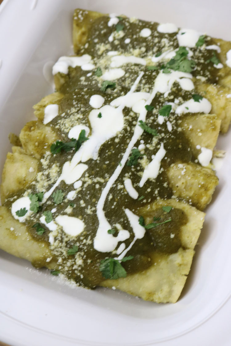 These chicken enchiladas made with a delicious tomatillo salsa verde sauce are a fantastic recipe to serve a hungry crowd. This traditional Mexican dish is made with white corn tortillas, salsa verde, chicken breast, and queso fresco. In under an hour, you can prepare a delicious meal that will be a hit at any family dinner. Easy-Enchiladas-Recipe