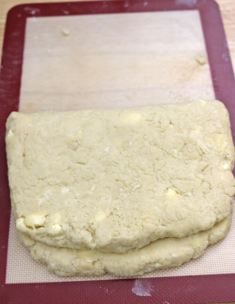 Turn the dough onto a floured surface. Roll it into a rectangle about 9x13 inches (it doesnโt have to be exact). I like to use my baking mat to guide me. Fold-the-dough