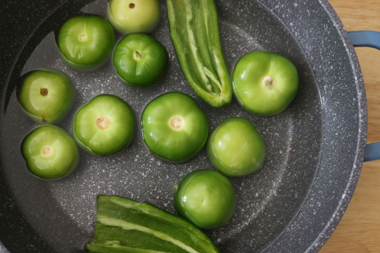 In a pot, add the tomatillos and jalapeno pepper. Pour in some water and simmer over high heat for about 10 minutes until they are soft. Green-enchilada-sauce-ingredients