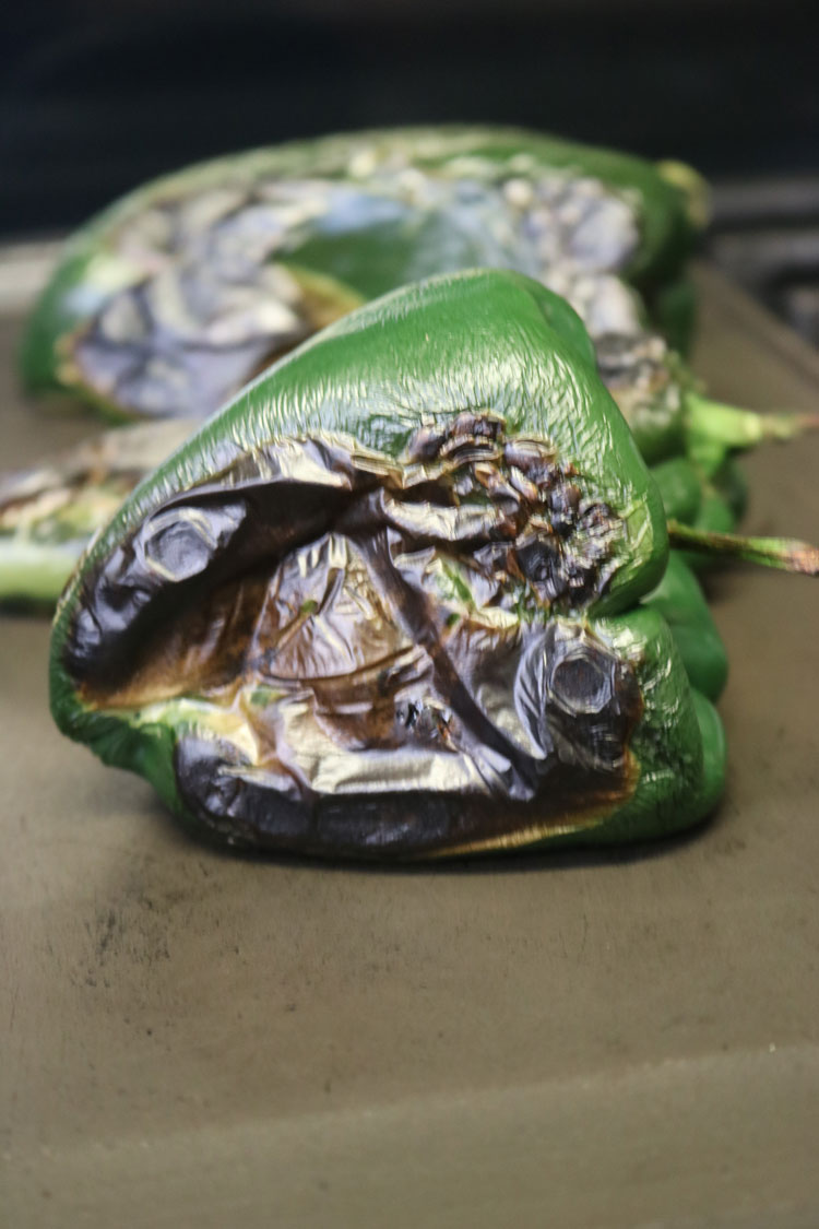 roast the poblano peppers until the skins are charred. Roast-the-poblano-peppers-until-the-skins-are-charred.