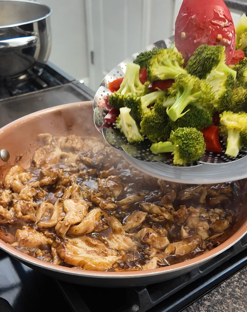 Once the sauce is thick and glossy, reduce the heat to low and add the chicken. Mix until the chicken is well-coated. Then, add the blanched mixed vegetables and toss until they are coated with the sauce. Once the sauce is thick and glossy, reduce the heat to low and add the chicken. Mix until the chicken is well-coated. Then, add the blanched mixed vegetables and toss until they are coated with the sauce.