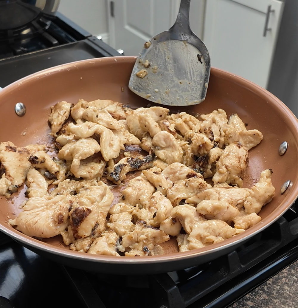 Add enough oil to coat the bottom in a wok or sautรฉ pan over medium-high heat. Once the oil is hot, add the marinated chicken and cook on both sides until it is fully cooked. Ensure-that-each-piece-of-chicken-is-cooked-evenly-by-separating-them.-If-needed,-cook-the-chicken-in-small-batches