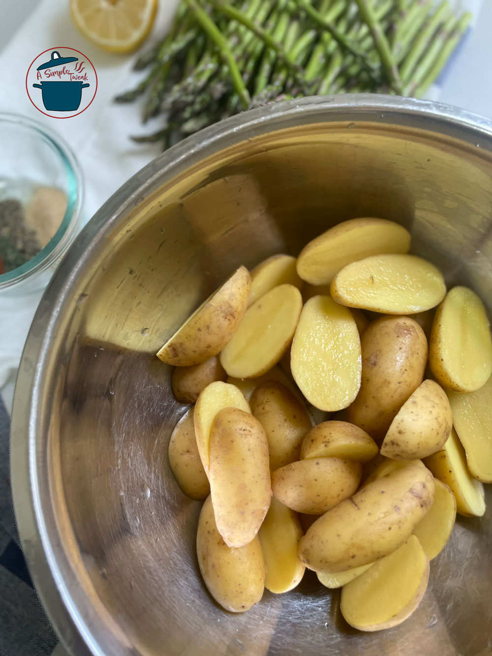 The first step is to wash and slice the fingerling potatoes. As for the Asparagus, trim asparagus stalks about 2-3 inches from the bottom. Fingerling-Potatoes-Recipe