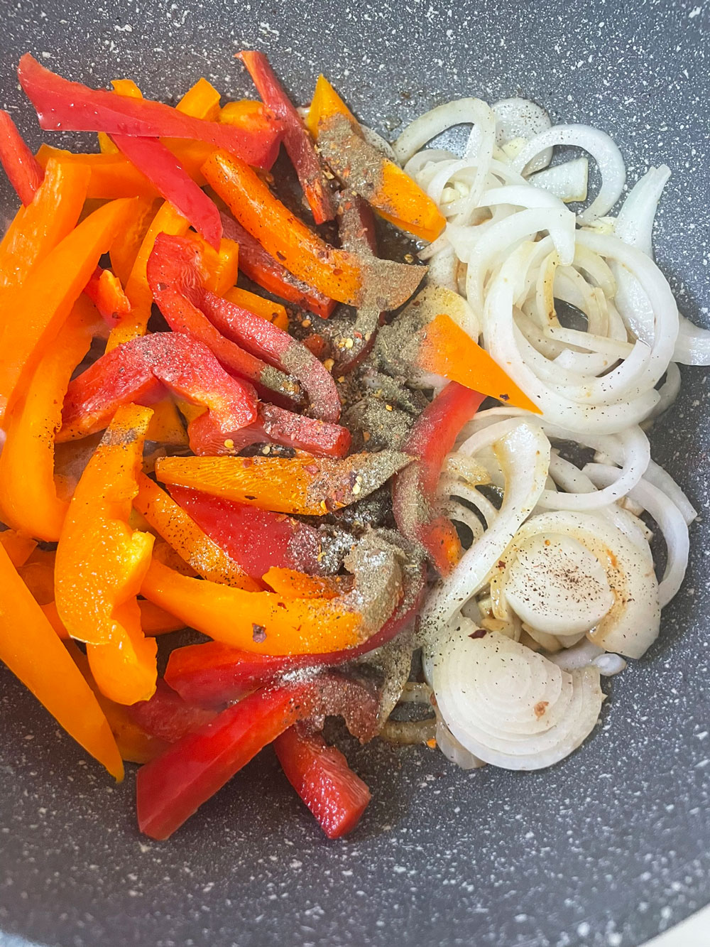 Next,-using-the-same-pan,-increase-the-heat-to-high-and-saute-the-onions-and-peppers.-Add-salt,-oregano,-black-pepper,-and-garlic. Next,-using-the-same-pan,-increase-the-heat-to-high-and-saute-the-onions-and-peppers.-Add-salt,-oregano,-black-pepper,-and-garlic.
