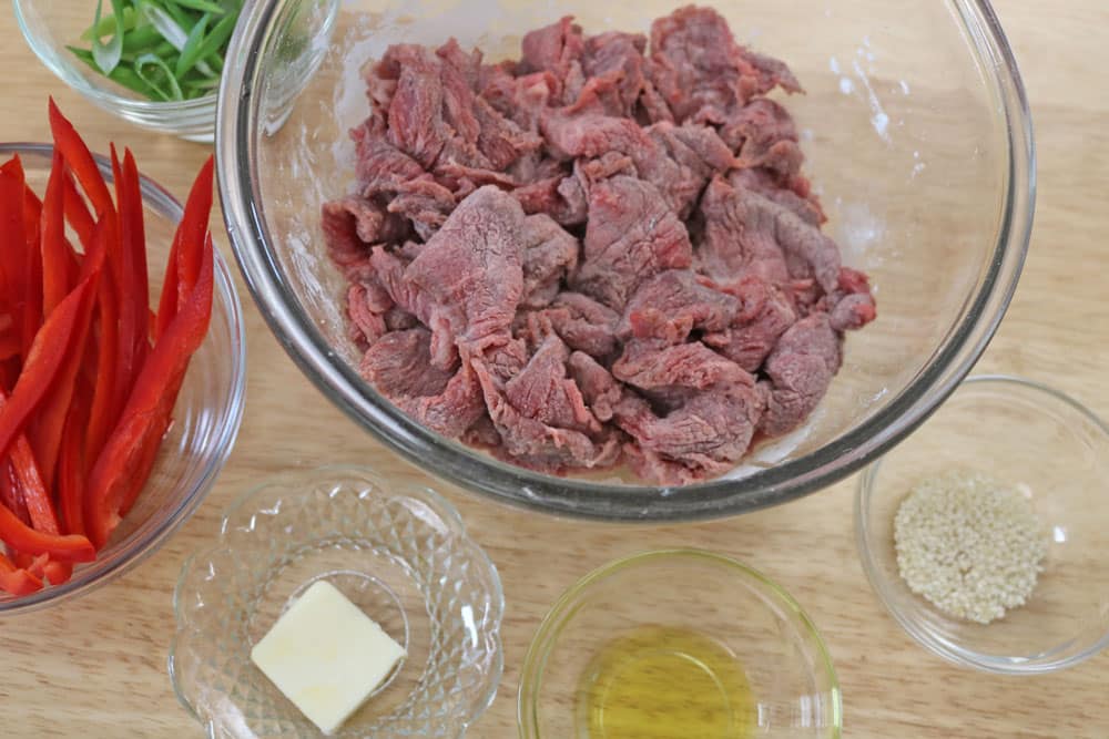 We-start-by-cutting-the-beef-into-bite-size-pieces-always-cutting-against-the-grain.-add-cornstarch-and-stir-to-coat-completely. We-start-by-cutting-the-beef-into-bite-size-pieces-always-cutting-against-the-grain.-add-cornstarch-and-stir-to-coat-completely.
