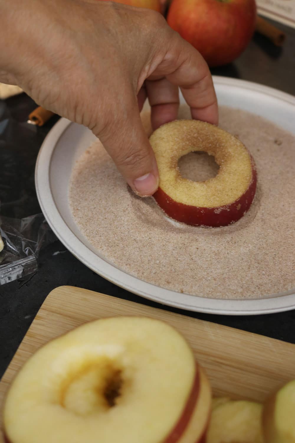Wash the apples then cut each apple into thick slices. Use the end of a piping tip or apple corer to cut out a circle in the middle. Coat the apple slices shape in the cinnamon sugar mixture. Wash the apples then cut each apple into thick slices. Use the end of a piping tip or apple corer to cut out a circle in the middle. Coat the apple slices shape in the cinnamon sugar mixture.