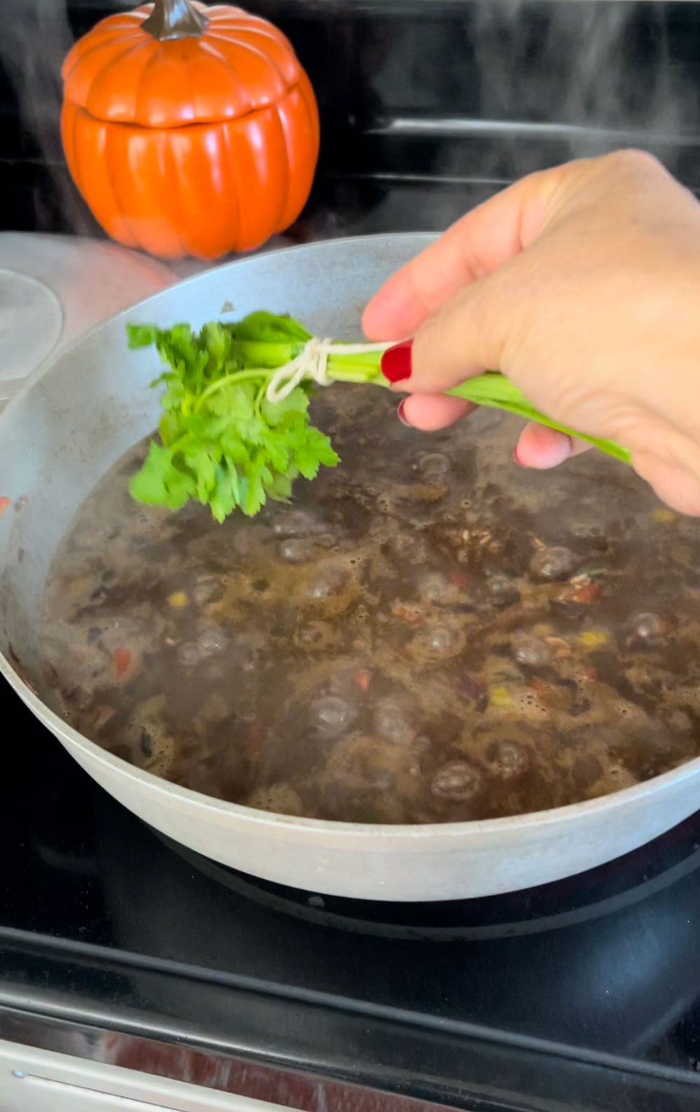 Next, add the herbs and cook uncovered on medium heat until most of the liquids have been absorbed. A good sign is seeing bubble pockets in the pot (about 8-10 minutes). Add-the-herbs-and-cook-uncovered-on-medium-heat-until-most-of-the-liquids-have-been-absorbed.-A-good-sign-is-seeing-bubble-pockets-in-the-pot