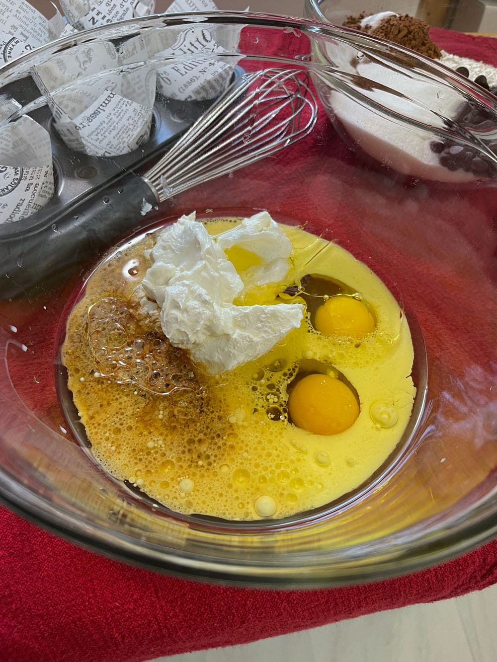 in a separate mixing bowl, add the eggs, sour cream, oil, milk, and vanilla extract. Whisk without overmixing. Wet-Ingredients